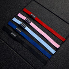 Set of lifting straps in red, blue, pink, and black on a textured black surface.